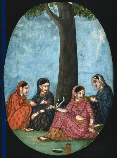 Four Indian ladies sitting under a tree next to a Shivling