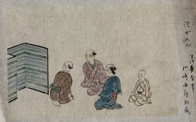 Four Japanese people seated, looking towards a screen