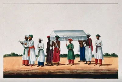Four Muslims carrying a coffin for burial at the mosque preceded by two men reading from a holy book