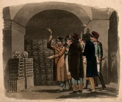 Gentlemen carrying torches visiting catacombs in Paris