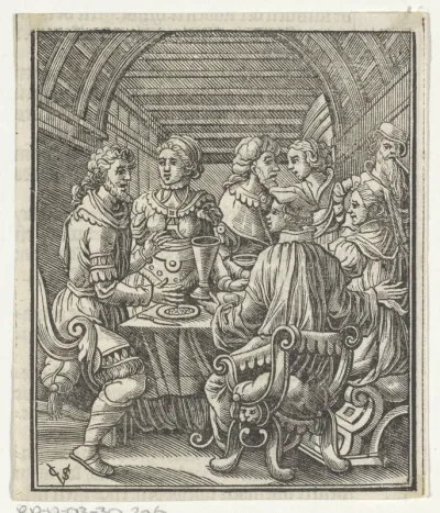 Gezelschap rondom een tafel met daarop een maaltijd