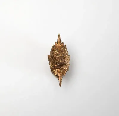 Gold earrings in the shape of a Makara