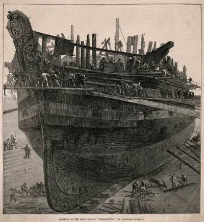 H.M.S. Dreadnought, a hospital ship, being broken up for salvage at Chatham Naval Dockyard, Kent. Wood engraving, 1875