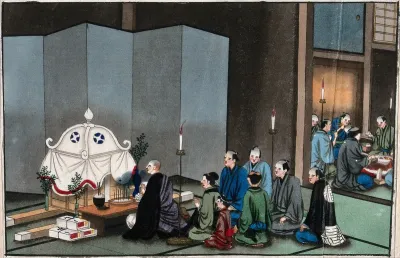 Japanese funeral customs: a Buddhist monk kneels before a coffin; mourners kneel behind him