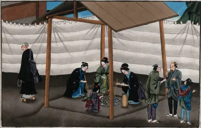 Japanese funeral customs: after the cremation: three women and a child pick bones from the ashes with chopsticks and place them in an urn
