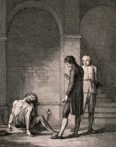 John Howard visiting a prisoner who is chained to the wall; the gaoler stands nearby