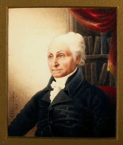 John Sherwen, head and shoulders; shelves with books in the background