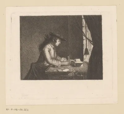 Jongeman aan een tafel bouwt een kaartenhuis