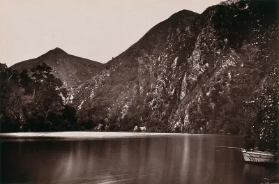 Knysna Lakes, South Africa: a lake with a boat and hills