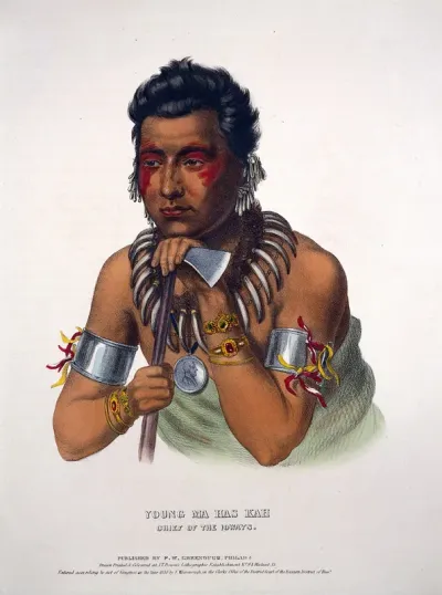 Ma-hos-kah (White Cloud) the Younger, a chief of the Iowa tribe, leaning on a tomahawk