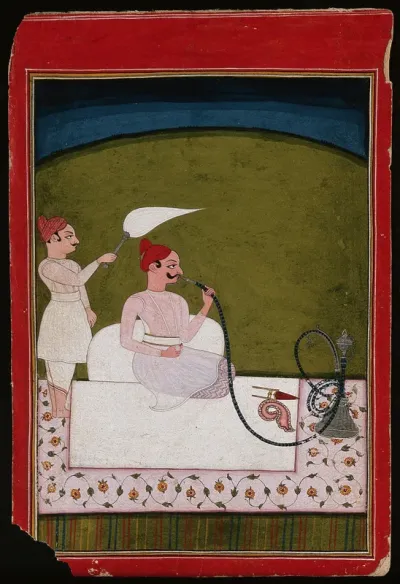 Maharaja Saudan Singh (?) smoking a hookah, while an attendant with a fly whisk stands behind him