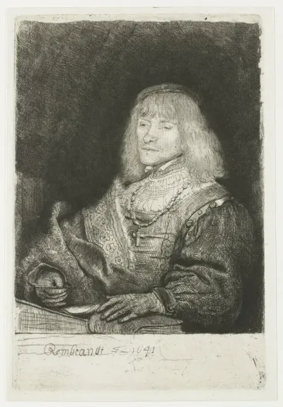 Man at a desk wearing a cross and chain