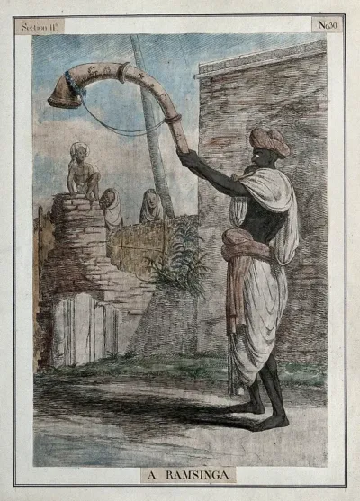 Man playing a ramsinga, a large snake-like wind instrument, Calcutta, West Bengal