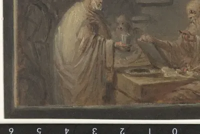 Man staande voor een tafel, waarachter twee mannen zitten