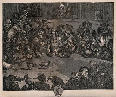Men are gathered around in a circle watching two cocks fight one another