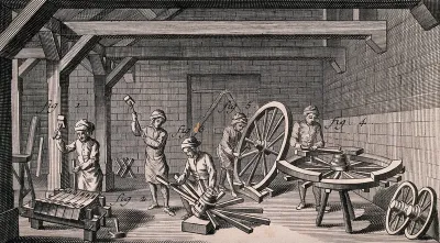 Men are working with mallets to fit the pieces together to make wheels