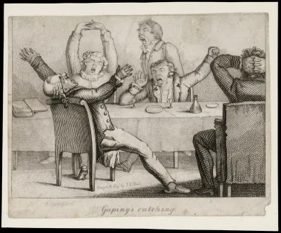 Men around a table yawning