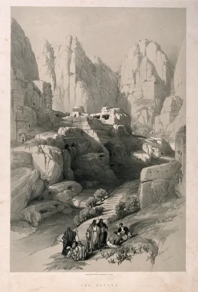 Men sitting to smoke by a ravine at Petra, Jordan