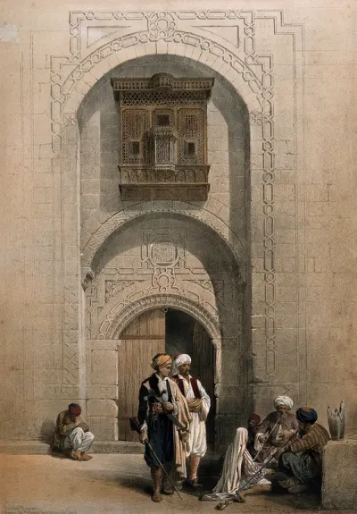 Men smoking outside an arabesque mansion in Cairo