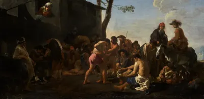 Men wrestling before a crowd