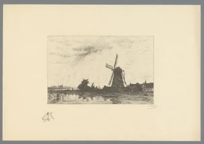 Molen en lage woningen aan een plas