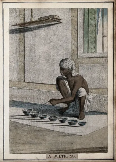Musician playing a jultrung, an instrument composed of china cups that are struck with sticks, Calcutta, West Bengal