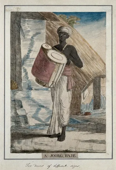 Musician with a percussion instrument made of two drums of different sizes joined together, and played with a drumstick, Calcutta, West Bengal