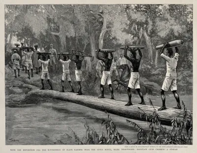 Nigerian porters carrying gun parts across the Benue river in a British expedition to suppress slavery