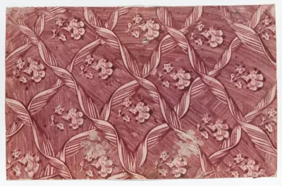 Paste paper with overall red floral and ribbon pattern