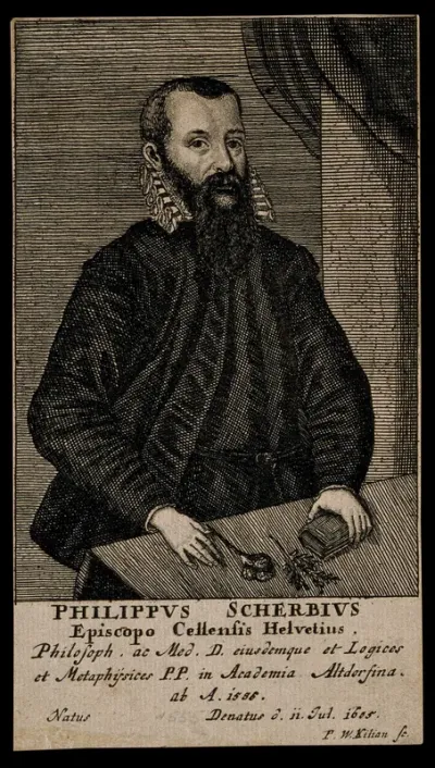 Philipp Scherb, standing at a table with a book and flowers on it