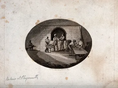 Plymouth: bakers working at an oven and a table