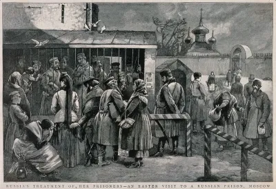 Prisoners behind bars opening on to a yard in Moscow being visited by men and women at Easter