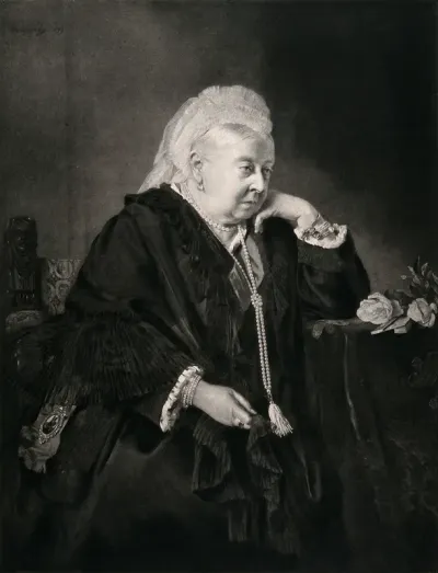 Queen Victoria at the age of eighty, seated in an armchair, her elbow resting on a table