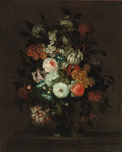 Roses, tulips, morning glory and other flowers in a glass vase on a ledge