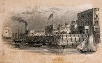 Royal Naval Hospital, Greenwich, a brick quay with wooden piers around it, with ships in the foreground, viewed from the river