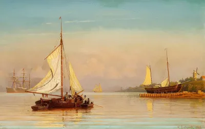 Sailing ships off the coast in the evening sun.
