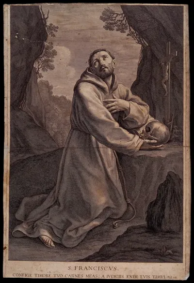 Saint Francis of Assisi in the wilderness, holding a skull, kneeling in front of a crucifix