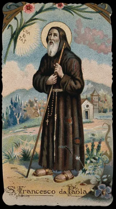 Saint Francis of Paula holding his walking stick with both hands and looking at the sun; church in the background on the right
