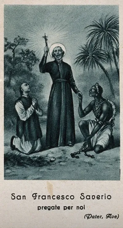 Saint Francis Xavier holding a crucifix; an Asian man and an African man are kneeling beside him