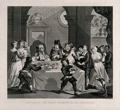 Sancho sits at a table laden with food with his physician Pedro Rezzio surrounded by an assortment of people including two youths who remove the dishes