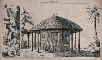 Scenery to be used in a toy theatre: a large hut with a straw roof has a chair outside and a table with a water barrel on it