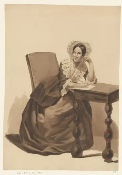 Schrijvende dame aan tafel