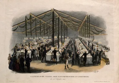 Scientists of the Austrian Empire at a large banquet in a tent, drinking a toast
