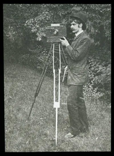 Self-Portrait with camera, tripod and pistol
