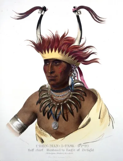 Shaumonekusse, a chief of the Oto (Otoe) tribe, wearing a crown hair piece with horns, a bear-claw necklace and a medallion
