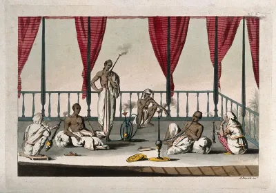 Six Indian men smoking a variety of pipes and hookas