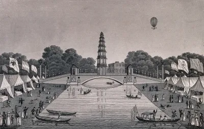 St. James's Park: people boating on the lake which has marquees with flags flying on its banks, a hot-air balloon flies overhead. Engraving, 1814