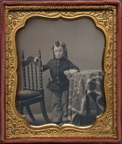 Standing boy with bottle curls