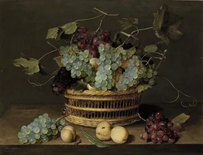 Still life with a basket of grapes en apricots on a wooden table