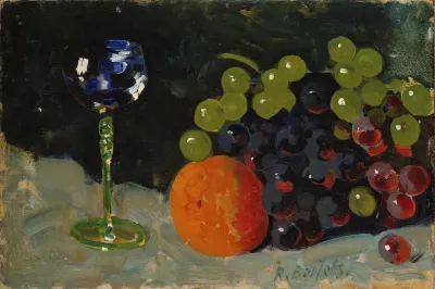 Still life with wineglass, grapes and blood orange